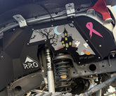 Close-up of a jeep's undercarriage with visible branding and stickers.